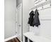 Mudroom with white wainscoting, storage bench, coat hooks and decor at 13163 N Departure W Blvd, Camby, IN 46113
