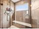 Bathroom shower featuring glass doors, tiled walls, seating bench and overhead shower at 13163 N Departure W Blvd, Camby, IN 46113
