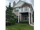 View of the home's exterior highlighting the brick facade, second story balcony, and attached garage at 13225 Deception Pass # 1200, Fishers, IN 46038