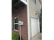 Attached one-car garage featuring brick and siding exterior and side yard at 13225 Deception Pass # 1200, Fishers, IN 46038