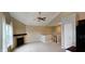 Open-concept living room with a fireplace, ceiling fan, neutral paint, and an open stairway at 13225 Deception Pass # 1200, Fishers, IN 46038