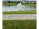 Scenic pond view with fountain, surrounded by lush green lawns, perfect for a tranquil escape at 13225 Deception Pass # 1200, Fishers, IN 46038