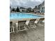 Relax by the community pool featuring comfortable lounge chairs and ample space for swimming at 13225 Deception Pass # 1200, Fishers, IN 46038
