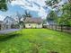 Spacious backyard with lush green grass, wood fence, and a trampoline at 1336 Lafayette Ave, Columbus, IN 47201