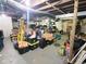 Unfinished basement with exposed ceiling, storage containers and ample space at 1336 Lafayette Ave, Columbus, IN 47201