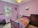 Cozy bedroom with rainbow striped bedding and a window at 1336 Lafayette Ave, Columbus, IN 47201