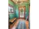 Inviting entryway boasting wood trim, a classic chandelier, and a convenient coat rack at 1336 Lafayette Ave, Columbus, IN 47201