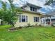 Charming exterior view of a yellow home with landscaped yard and mature tree at 1336 Lafayette Ave, Columbus, IN 47201