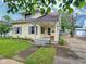 Charming home featuring a well-maintained lawn, inviting porch, and beautiful landscaping at 1336 Lafayette Ave, Columbus, IN 47201