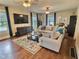 Spacious living room featuring hardwood floors, comfortable seating, and natural light at 1336 Lafayette Ave, Columbus, IN 47201