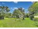 A full backyard view with a playset, green grass, and ample parking at 1617 S Whittier Pl, Indianapolis, IN 46203