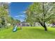 Backyard view with playset and gray sided house and garage at 1617 S Whittier Pl, Indianapolis, IN 46203