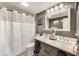 Modern bathroom with double sinks, large mirror and shower at 1617 S Whittier Pl, Indianapolis, IN 46203
