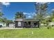Inviting home with a covered front porch, mature trees, and a well-maintained lawn at 1617 S Whittier Pl, Indianapolis, IN 46203
