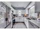 Modern kitchen with white cabinets, stainless steel appliances, and granite countertops at 1617 S Whittier Pl, Indianapolis, IN 46203