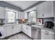 Well-lit kitchen with white cabinets, stainless steel appliances and granite countertops at 1617 S Whittier Pl, Indianapolis, IN 46203