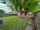 Backyard featuring a red shed, a mature tree, and a wood fence at 1653 Wade St, Indianapolis, IN 46203