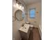 This bathroom features a single sink, a modern mirror, and new lighting at 1653 Wade St, Indianapolis, IN 46203