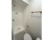 Modern bathroom featuring a tiled shower with bronze fixtures, alongside a sleek toilet at 1653 Wade St, Indianapolis, IN 46203