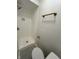 Modern bathroom featuring a tiled shower with bronze fixtures, alongside a sleek toilet at 1653 Wade St, Indianapolis, IN 46203
