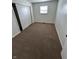 This carpeted bedroom features a large closet and a window offering natural light at 1653 Wade St, Indianapolis, IN 46203