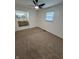 Bedroom with neutral carpet and a glimpse into an adjacent bathroom; simple and comfortable design at 1653 Wade St, Indianapolis, IN 46203