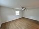 Spacious bedroom with hardwood floors, ceiling fan and natural light from the window at 1653 Wade St, Indianapolis, IN 46203