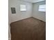 This carpeted bedroom has two windows for ample light and a closet at 1653 Wade St, Indianapolis, IN 46203