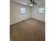 This carpeted bedroom features two windows, a ceiling fan, and natural light at 1653 Wade St, Indianapolis, IN 46203