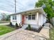 Charming single-story home with brick facade, landscaped front yard, and inviting entryway at 1653 Wade St, Indianapolis, IN 46203
