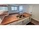 Modern kitchen with stainless steel sink, butcher block countertops, and sleek black tile at 1653 Wade St, Indianapolis, IN 46203