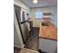Modern kitchen featuring stainless steel appliances, wood countertops, and stylish black hexagon tile floors at 1653 Wade St, Indianapolis, IN 46203