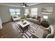 Bright living room featuring neutral furniture, ceiling fan, and modern decor and geometric area rug at 1653 Wade St, Indianapolis, IN 46203