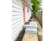 Side of house with an orange door and concrete steps at 1653 Wade St, Indianapolis, IN 46203