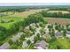 Aerial view of a quiet neighborhood with a mix of houses surrounded by fields and greenery at 16732 Maraschino Dr, Noblesville, IN 46062