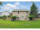 Spacious backyard featuring a patio area with trees and garden beds around a home at 16732 Maraschino Dr, Noblesville, IN 46062