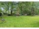 Beautiful backyard with a large grassy area and mature trees providing ample shade at 16732 Maraschino Dr, Noblesville, IN 46062