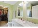 Bright bathroom with double sinks, marble countertop, and walk-in closet at 16732 Maraschino Dr, Noblesville, IN 46062