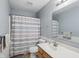 Neutral bathroom featuring a vanity, toilet, and shower with a striped curtain at 16732 Maraschino Dr, Noblesville, IN 46062
