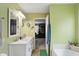 Bright bathroom with double sinks, marble countertop, and bathtub with view at 16732 Maraschino Dr, Noblesville, IN 46062