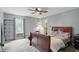 Serene bedroom with a classic wooden bed frame, large window, and a ceiling fan at 16732 Maraschino Dr, Noblesville, IN 46062