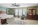 Spacious bedroom featuring green walls, a ceiling fan, and three large windows at 16732 Maraschino Dr, Noblesville, IN 46062