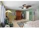 Bright bedroom with a ceiling fan, colorful rug, and a comfortable chair at 16732 Maraschino Dr, Noblesville, IN 46062