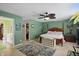 Spacious bedroom featuring green walls, a ceiling fan, and an attached bathroom with a walk-in closet at 16732 Maraschino Dr, Noblesville, IN 46062