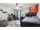 Cozy bedroom featuring a gray color scheme, ceiling fan, and well-lit desk area at 16732 Maraschino Dr, Noblesville, IN 46062