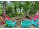 Inviting fire pit area surrounded by colorful Adirondack chairs, perfect for outdoor gatherings at 16732 Maraschino Dr, Noblesville, IN 46062