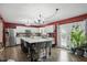 Well-lit kitchen featuring white cabinets, a kitchen island, stainless appliances, and hardwood floors at 16732 Maraschino Dr, Noblesville, IN 46062