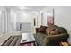 Upstairs living area with a comfy sofa, colorful rug, and neutral walls at 16732 Maraschino Dr, Noblesville, IN 46062