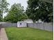 Spacious backyard featuring a shed, green grass and a fenced perimeter at 1728 Newton St, Columbus, IN 47201