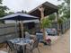 Outdoor patio featuring comfortable furniture, plants, and an umbrella covered table at 1728 Newton St, Columbus, IN 47201